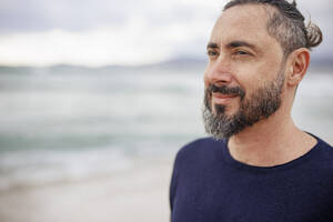 Contemplative man with beard at beach - JOSEF21043