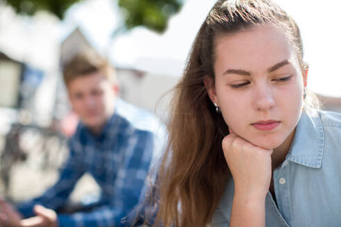 Unhappy Teenage Couple Having Argument In Urban Setting - INGF12098