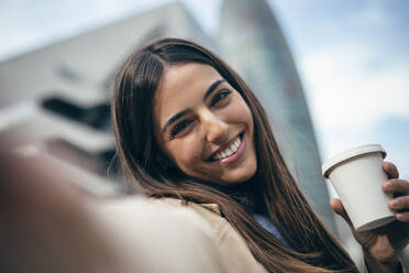 Happy woman taking selfie with coffee cup - JSRF02642