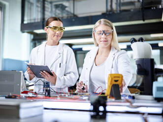 Lächelnde junge Wissenschaftler bei der Arbeit im Labor - CVF02492