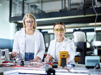 Young scientists working in electronics laboratory - CVF02494