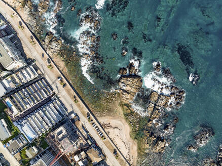 Aerial Top Down View Of Modern Luxury Seaside Apartment Buildings And Ocean Rocks At Playa Cochoa Beach In Valparaiso, Chile. - AAEF21900