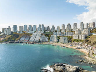 Aerial View Of Modern Luxury Seaside Apartment Buildings At Playa Cochoa Beach In Valparaiso, Chile. - AAEF21901