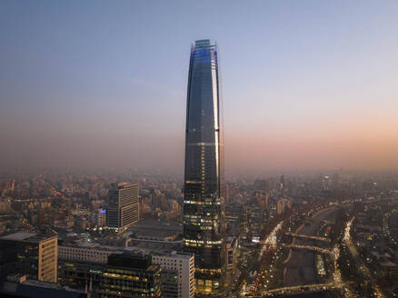 Aerial View Of Tall Skyscraper And Cityscape At Sunset In Downtown Santiago, Chile. - AAEF21904