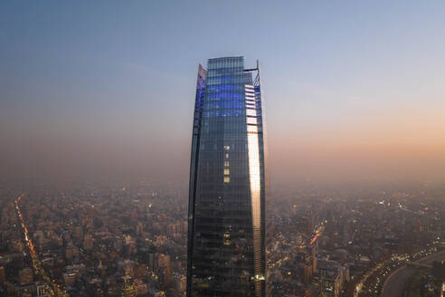 Aerial View Of Tall Skyscraper And Cityscape In Background At Sunset In Downtown Santiago, Chile. - AAEF21905