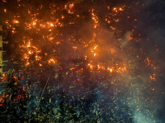 Aerial view of Firefighters and mass people were working to douse the massive fire in the capital city Dhaka, Bangladesh. - AAEF21966