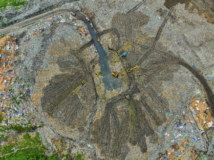 Aerial view of cranes working at the largest waste dumping yard in Aminbazar, Dhaka, Bangladesh. - AAEF22011