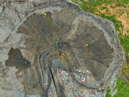 Aerial view of cranes working at the largest waste dumping yard in Aminbazar, Dhaka, Bangladesh. - AAEF22013