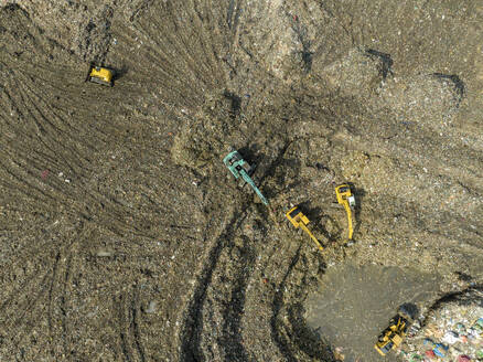 Aerial view of cranes working at the largest waste dumping yard in Aminbazar, Dhaka, Bangladesh. - AAEF22015