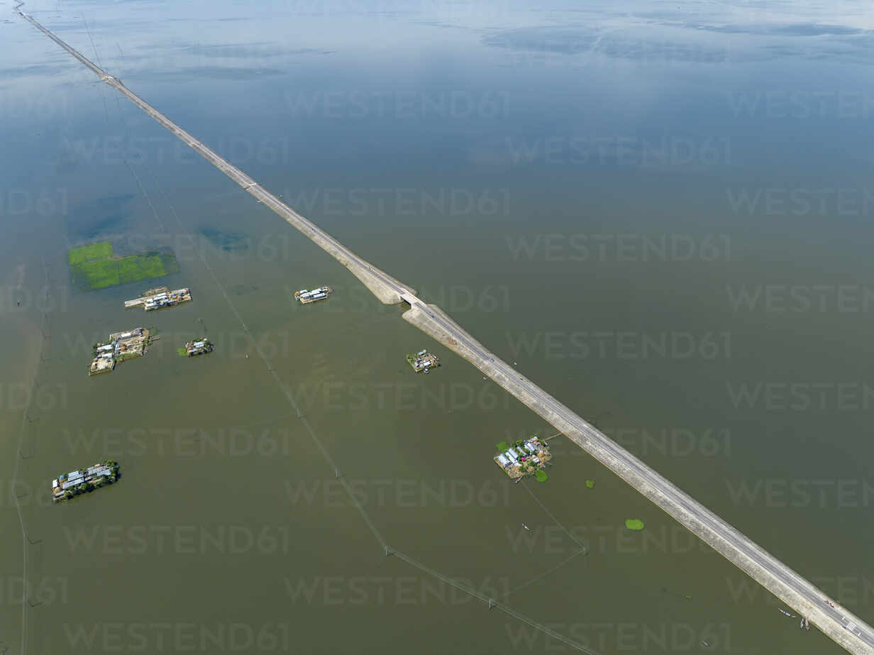 Aerial view of a road across the flooded swamp in Astagram, Kishoreganj,  Bangladesh. stock photo