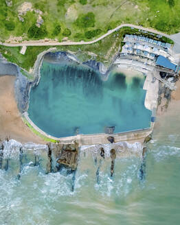 Aerial view of Bude Seapool, Summerlease beach during an incoming tide, Bude, Cornwall, United Kingdom. - AAEF22066