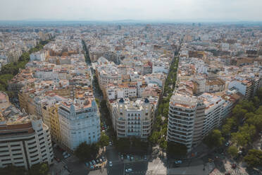 Aerial view of typical Valencian houses with skyline of the city and roads full of trees, Valencia, Spain. - AAEF22072