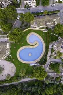 Aerial view of a pool with a strange shape in a residential area, Zona Encinas, Cumbre del Sol, Alicante, Spain. - AAEF22099