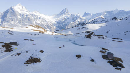 Aerial view of snowy landscape and mountains Mittelhorn, Schreckhorn and Dossen in Grindelwald, Switzerland. - AAEF22212