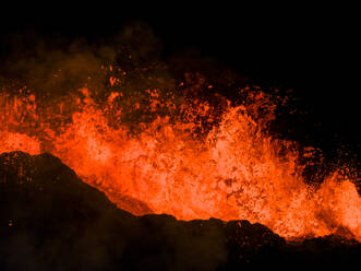 Aerial view of lava flowing from Litli-Hrutur (Little Ram) Volcano during an eruption on Fagradalsfjall volcanic area in southwest Iceland at night, it's a fissure eruption started on the Reykjanes Peninsula, Iceland. - AAEF22226