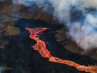 Aerial view of lava flowing from Litli-Hrutur (Little Ram) Volcano during an eruption on Fagradalsfjall volcanic area in southwest Iceland at night, it's a fissure eruption started on the Reykjanes Peninsula, Iceland. - AAEF22232