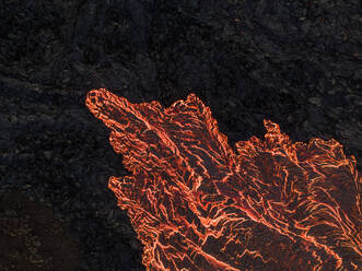 Aerial view of lava flowing from Litli-Hrutur (Little Ram) Volcano during an eruption on Fagradalsfjall volcanic area in southwest Iceland at night, it's a fissure eruption started on the Reykjanes Peninsula, Iceland. - AAEF22233