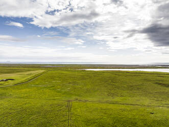 Aerial view of a green valley along the coastline in Hvolsvollur, Southern Region, Iceland. - AAEF22321