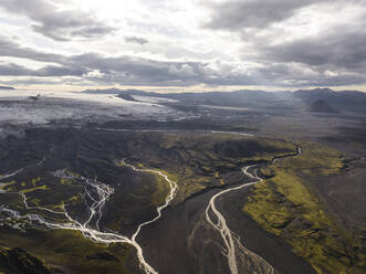 Aerial view of a river estuary crossing the valley with mountain in background, Kirkjubaejarklaustur, Southern Region, Iceland. - AAEF22355