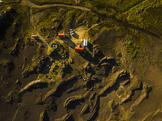 Aerial view of a few houses along the mountain road near Hella, Southern Region, Iceland. - AAEF22377