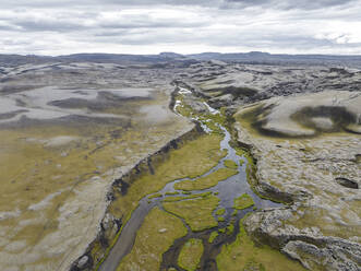 Aerial view of Ulfarsdalur river streaming across the valley in Kirkjubaejarklaustur, Southern region, Iceland. - AAEF22413