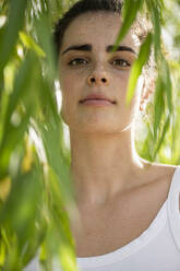 Young beautiful woman amidst plants - LMCF00594