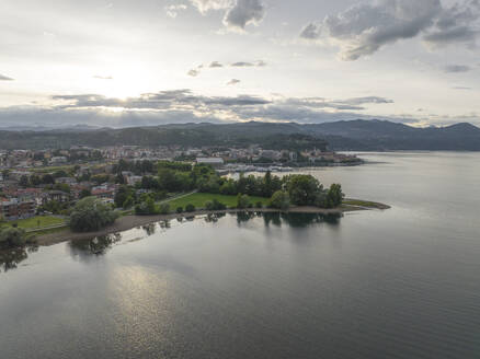 Aerial view of Arona, a small town along the Lago Maggiore (Lake Maggiore) at sunset, Novara, Piedmont, Italy. - AAEF22482