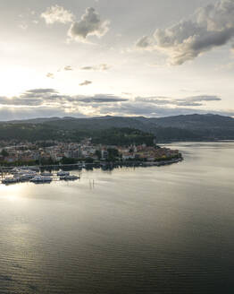 Aerial view of Arona, a small town along the Lago Maggiore (Lake Maggiore) at sunset, Novara, Piedmont, Italy. - AAEF22483