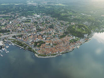 Aerial view of Arona, a small town along the Lago Maggiore (Lake Maggiore) at sunset, Novara, Piedmont, Italy. - AAEF22487