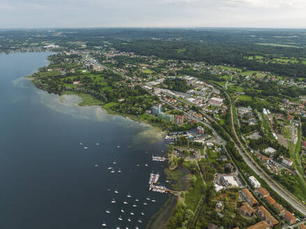 Aerial view of trees with park along the shore at Lago Maggiore (Lake Maggiore) at sunset, Novara, Piedmont, Italy. - AAEF22492