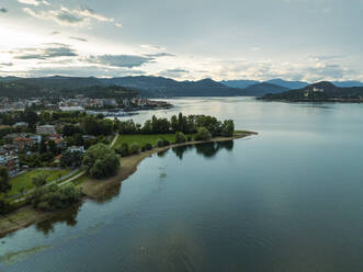 Aerial view of Arona residential area along the Lago Maggiore (Lake Maggiore) at sunset, Novara, Piedmont, Italy. - AAEF22493