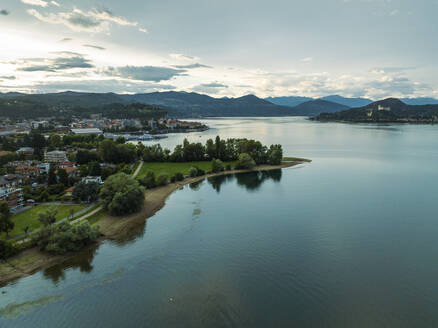 Aerial view of Arona residential area along the Lago Maggiore (Lake Maggiore) at sunset, Novara, Piedmont, Italy. - AAEF22493