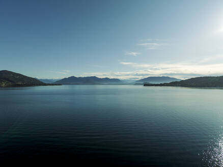 Aerial view of Lago Maggiore (Lake Maggiore) at sunrise, Meina, Novara, Piedmont, Italy. - AAEF22494