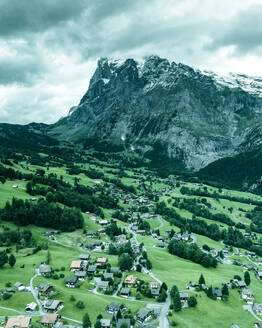 Aerial view of Grindelwald, a small town in the valley with the Wetterhorn mountain in background on the Swiss Alps, Canton of Bern, Switzerland. - AAEF22508