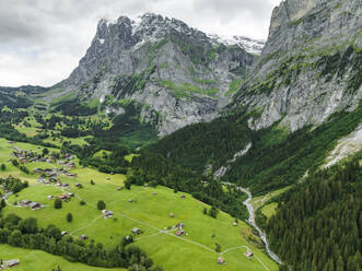 Aerial view of Schwarze Lutschine river in Grindelwald town with Bernese Alps in background, Swiss Alps, Bern, Switzerland. - AAEF22513