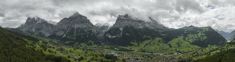 Panoramic aerial view of Bernese Alps in Grindelwald town in summertime, Swiss Alps, Canton of Bern, Switzerland. - AAEF22526