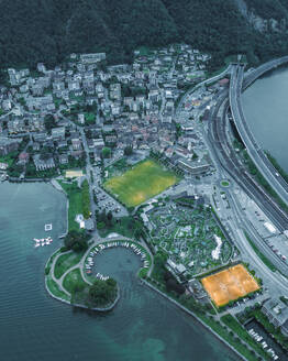 Luftaufnahme eines Fußballplatzes in Melide, einer kleinen Stadt am Luganersee, bei Sonnenuntergang im Tessin, Schweiz. - AAEF22559