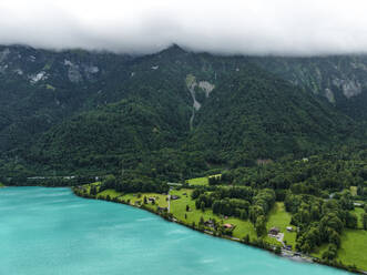 Aerial view of Brienzersee Lake in summertime during a rainy day with low clouds, Bonigen, Bern, Switzerland. - AAEF22653