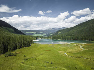 Aerial view of Dobbiaco Lake on the Dolomites mountain range, Toblach, Trentino, South Tyrol, Italy. - AAEF22682