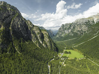 Aerial view of a road crossing the valley across Tre Cime Natural park (Drei Zinnen) on the Dolomites area, Trentino, South Tyrol, Italy. - AAEF22732