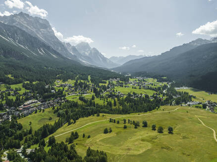 Aerial view of houses in a valley with mountain in background near Cortina d'Ampezzo, Belluno province, Dolomites area, Veneto, Italy. - AAEF22756