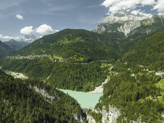 Aerial view of Valle di Cadore Lake, a mountain lake on the Dolomites with Mount Antelao in background in Valle di Cadore, Veneto, Belluno, Italy. - AAEF22763