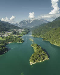 Aerial view of Caprioli Island (Isola dei Caprioli) on Cadore Lake (Lago di Cadore) on the Dolomites Mountains, Belluno, Veneto, Italy. - AAEF22775