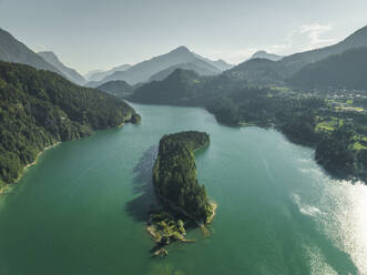 Aerial view of Caprioli Island (Isola dei Caprioli) on Cadore Lake (Lago di Cadore) on the Dolomites Mountains, Belluno, Veneto, Italy. - AAEF22781