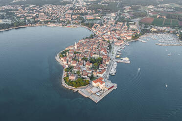 Aerial view of Porec at sunset, a small town along the Adriatic Sea coastline in Istria, Croatia. - AAEF22791