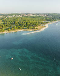 Aerial view of a beautiful beach along the Adriatic Sea coastline at sunset near Pula, Istria, Croatia. - AAEF22803