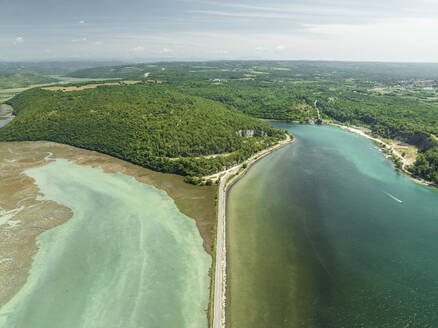 Luftaufnahme von Fahrzeugen auf einer Straße, die die Lagune Mirna und den Fluss Mirna überquert, Antenal, Istrien, Kroatien. - AAEF22846