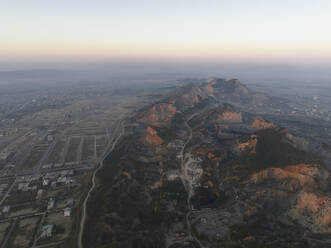 Aerial view of hills during sunrise in residential area B-17 in Islamabad, Pakistan Capital city. - AAEF22890