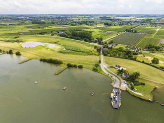Aerial view of river Nederrijn with floodplains, fruit orchards and crossing ferry between Eck en Wiel and Amerongen, Gelderland, Netherlands. - AAEF22905