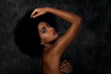 Portrait of pretty afro american woman in a studio for a beauty session - Beautiful girl posing on colored background - DMDF05038